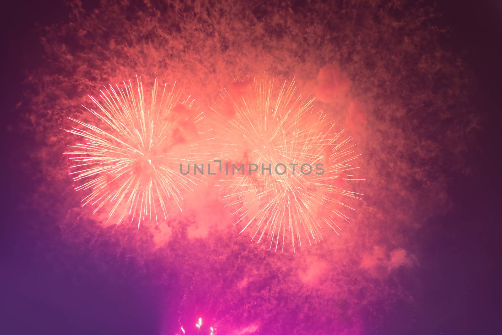 Fireworks in night dark sky with smoke after explosions