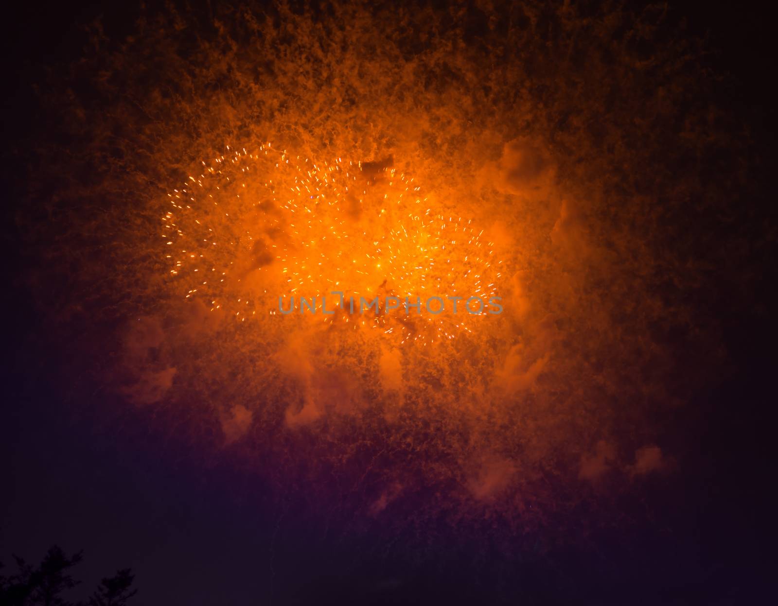 Fireworks in night dark sky with smoke after explosions