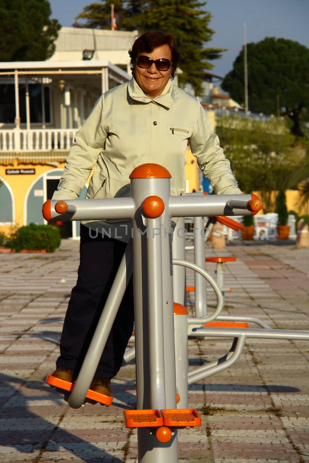 old woman doing sport in park by mturhanlar