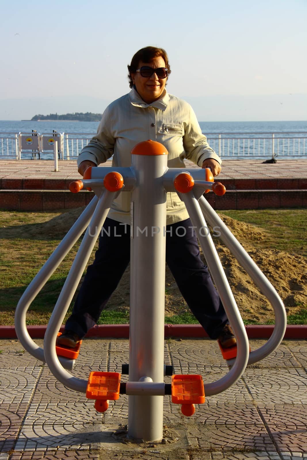 old woman doing sport in morning with tools