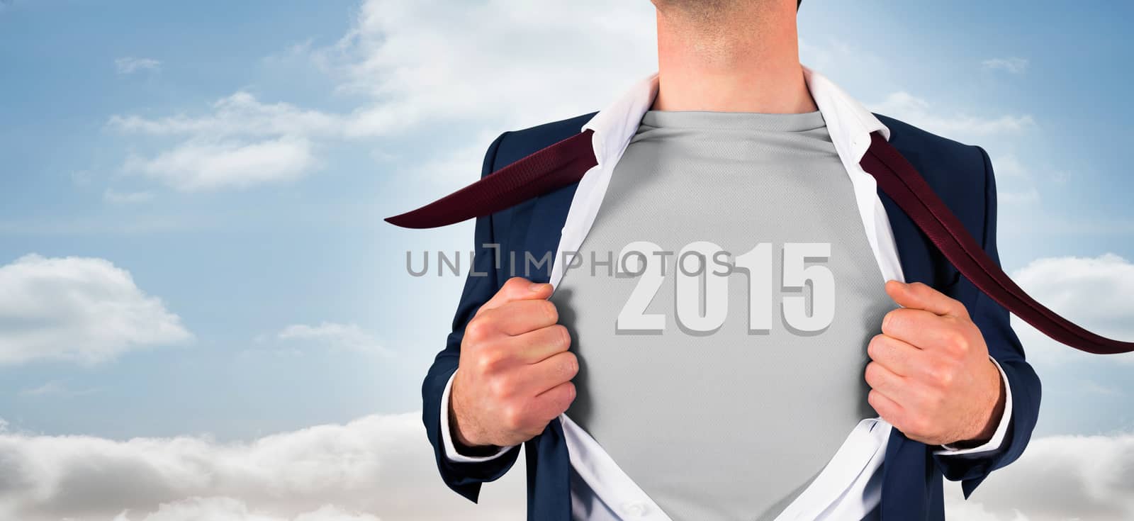 Businessman opening shirt in superhero style against view from balcony into bright sky