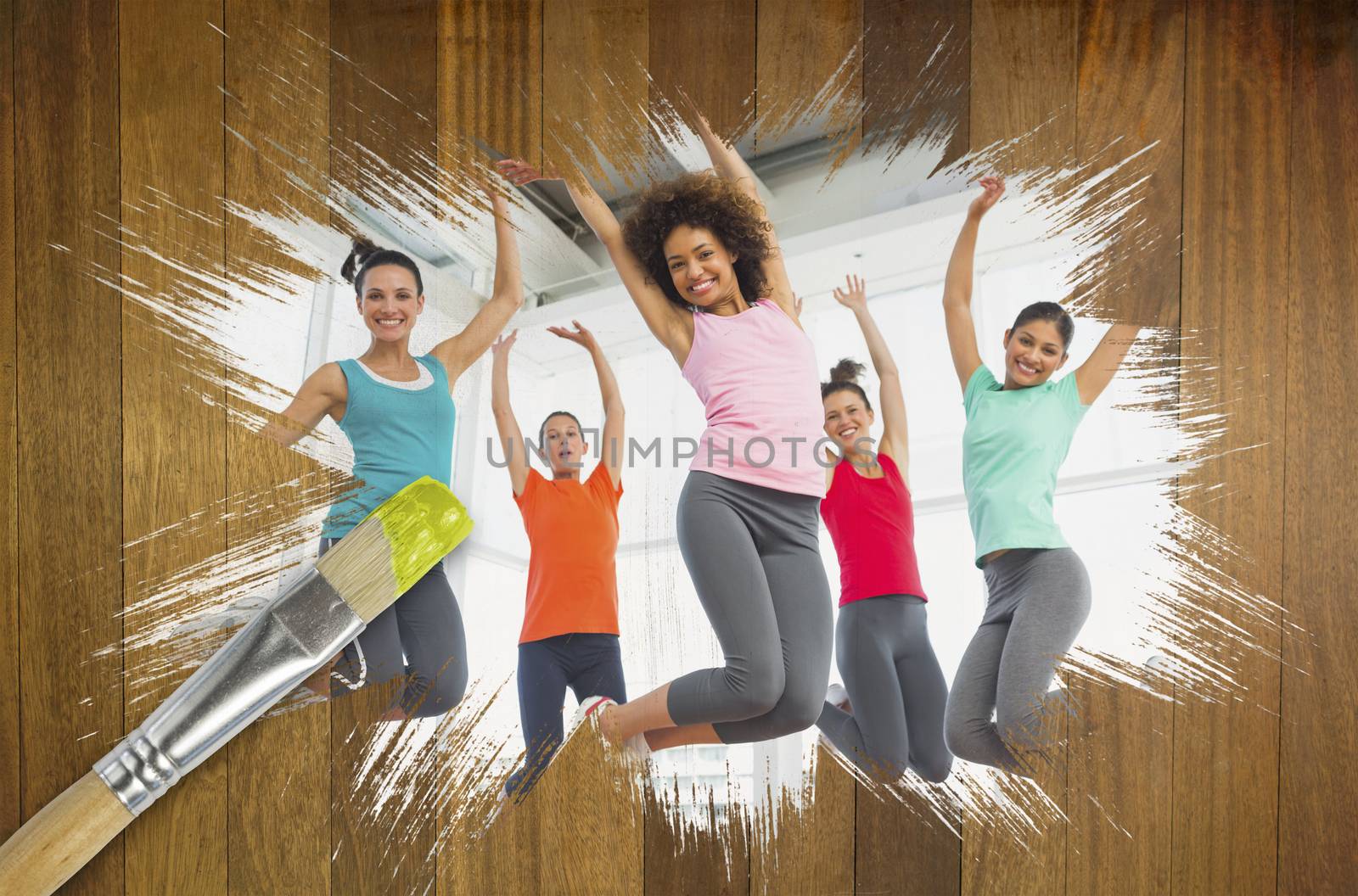 Composite image of fitness class at the gym with paintbrush dipped in yellow against wooden surface with planks
