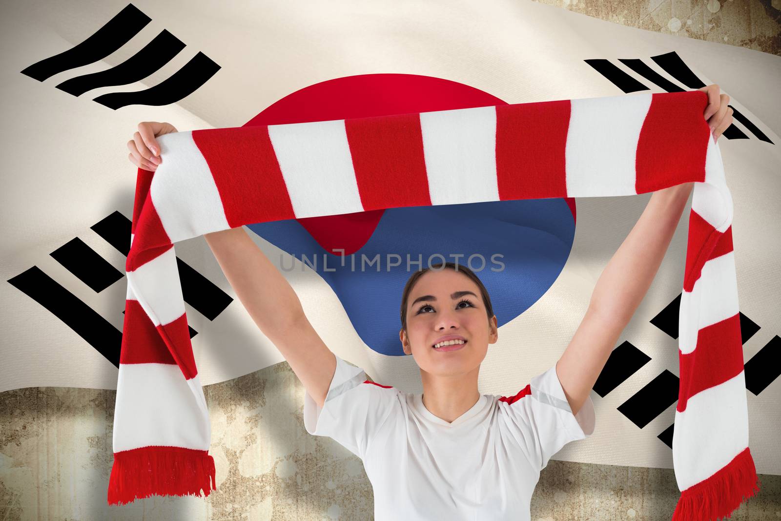 Football fan waving red and white scarf against korea republic flag