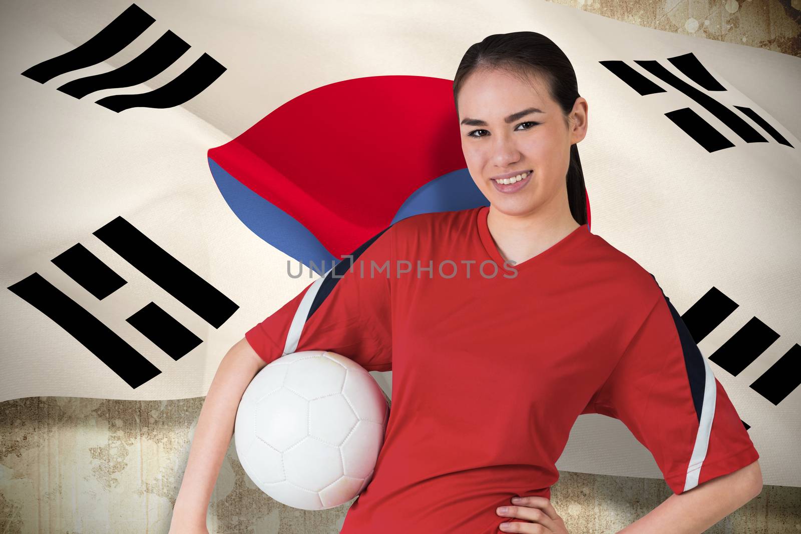 Smiling asian football fan looking at camera by Wavebreakmedia