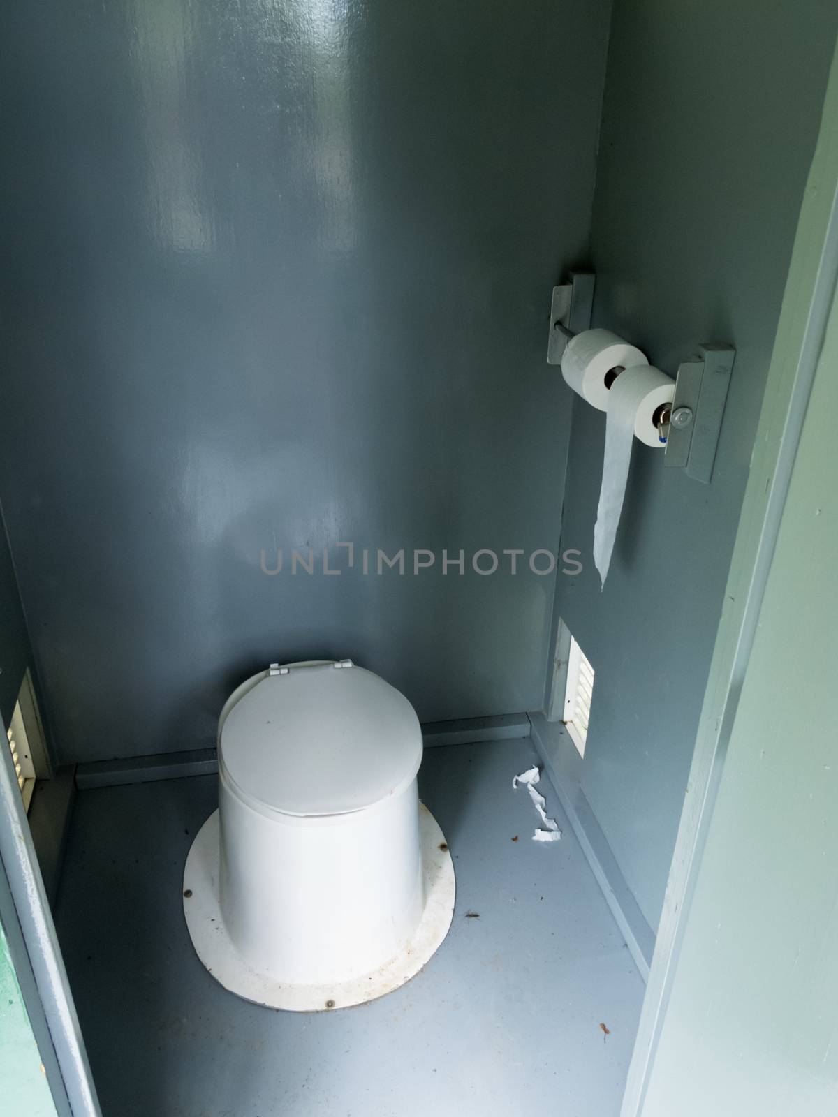 Campground pit toilet outhouse inside white plastic toilet and dirty interior to the toilet bowl