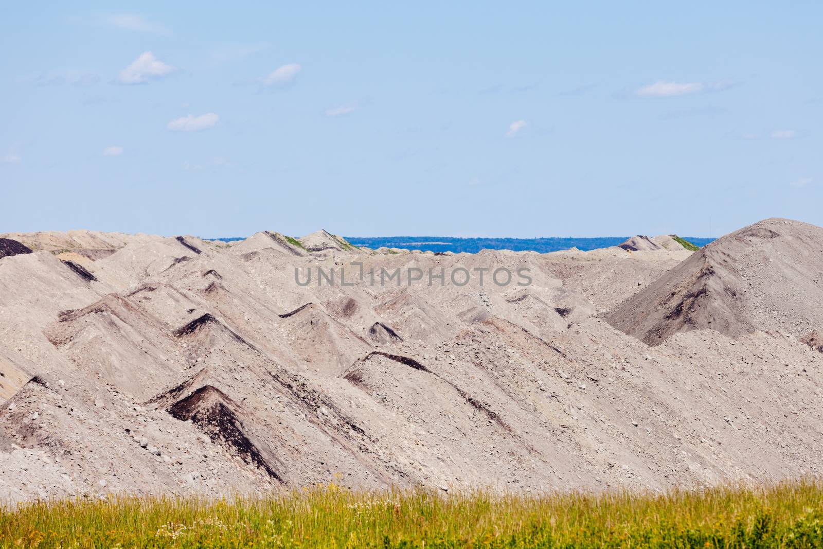 Coal mine tailings moon-like landscape in Alberta, Canada, resource mining industry background abstract