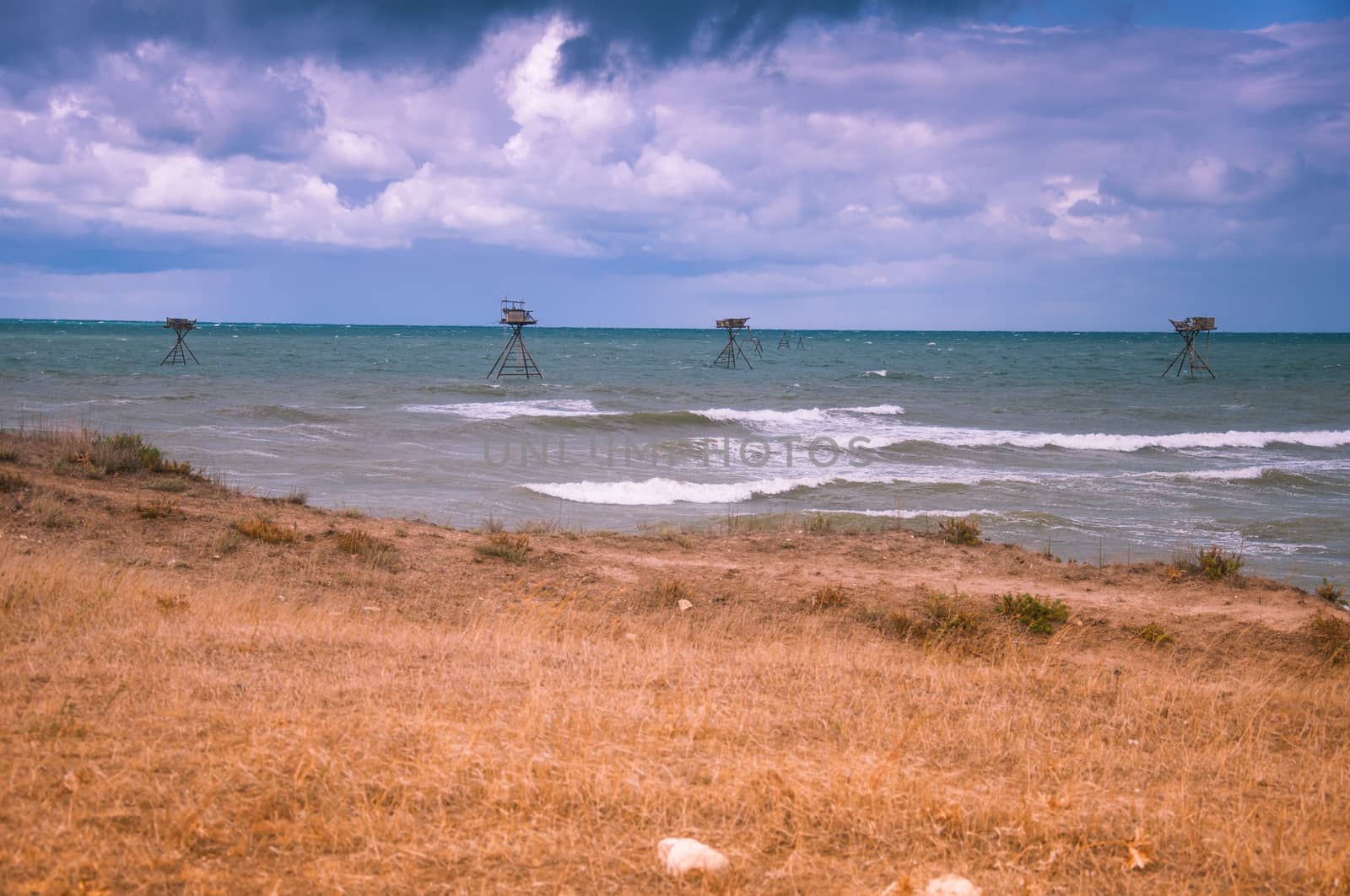 Seascape with fishing rigs. Stormy sky. West coast of Crimea.