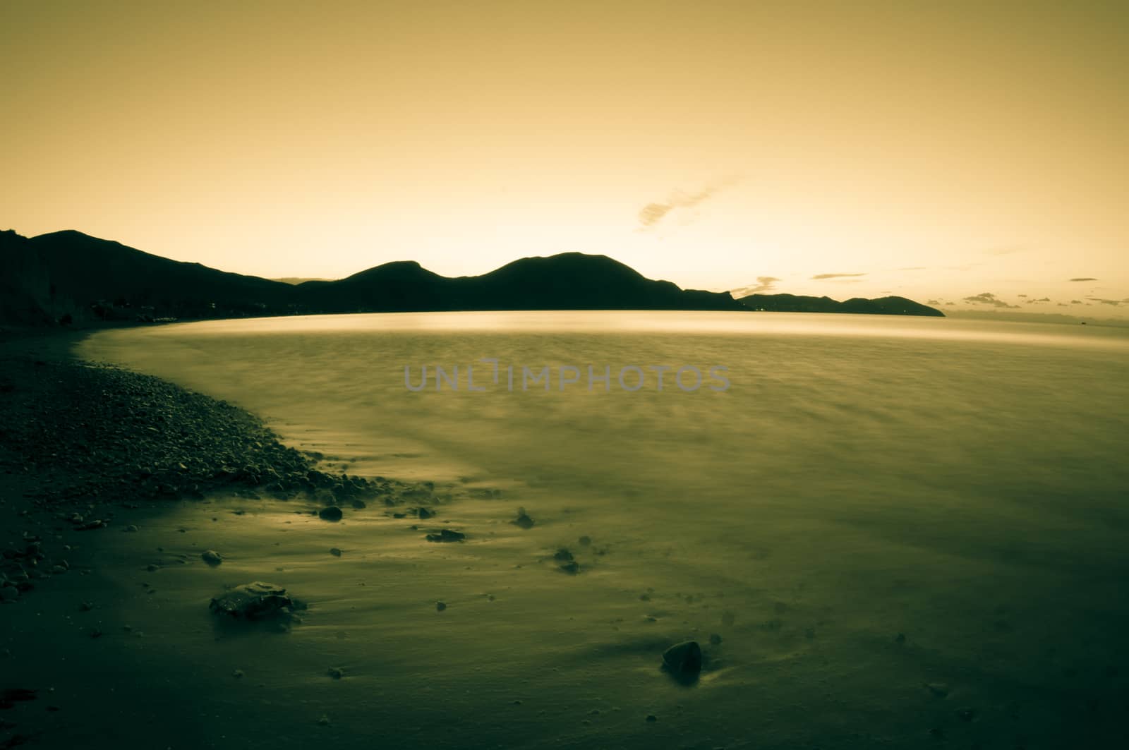 Morning sea. Beach, rocks, sky. Empty, serene landscape. Toned.