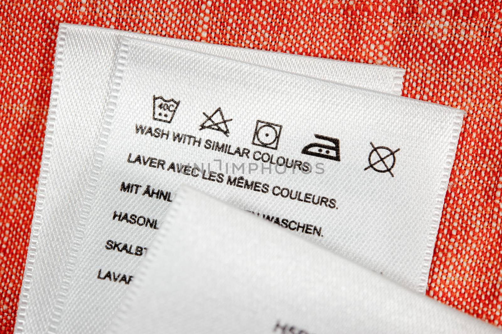 Clothing label washing instruction tag. Close up.