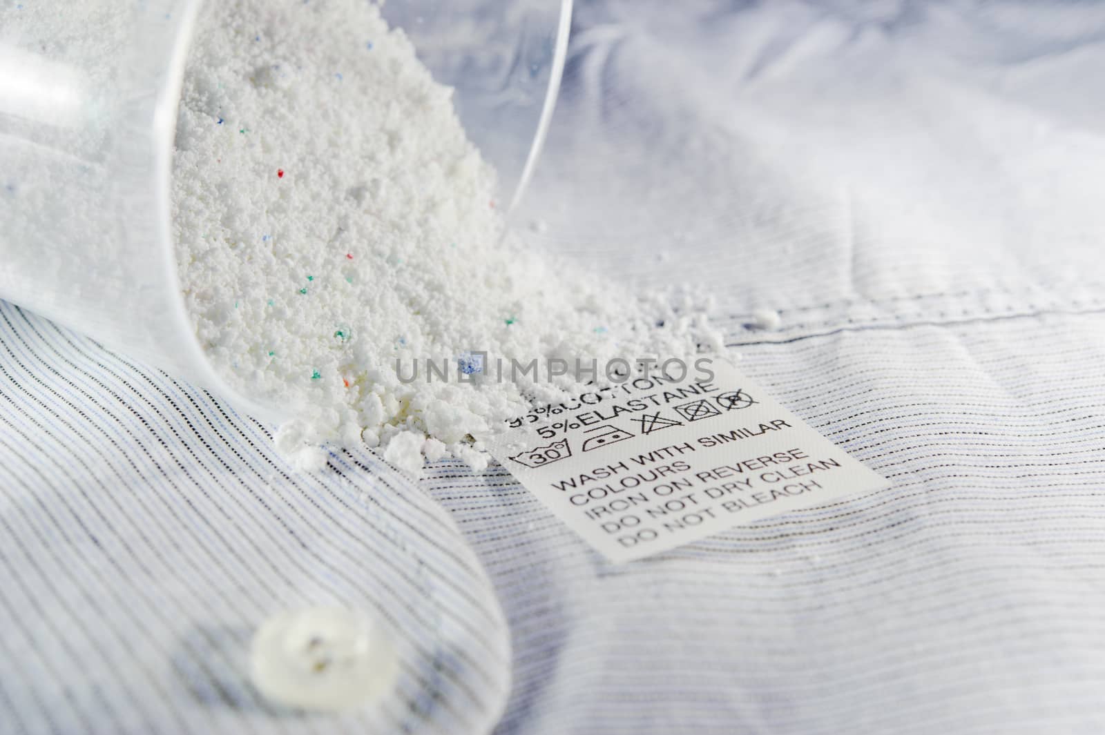 Close up view on an washing label tag and washing powder.