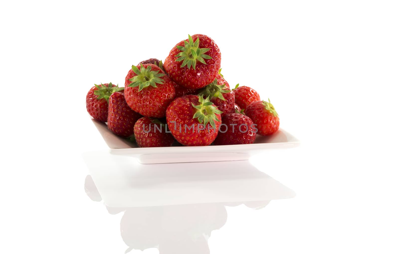 plate with red strawberries isolated on white