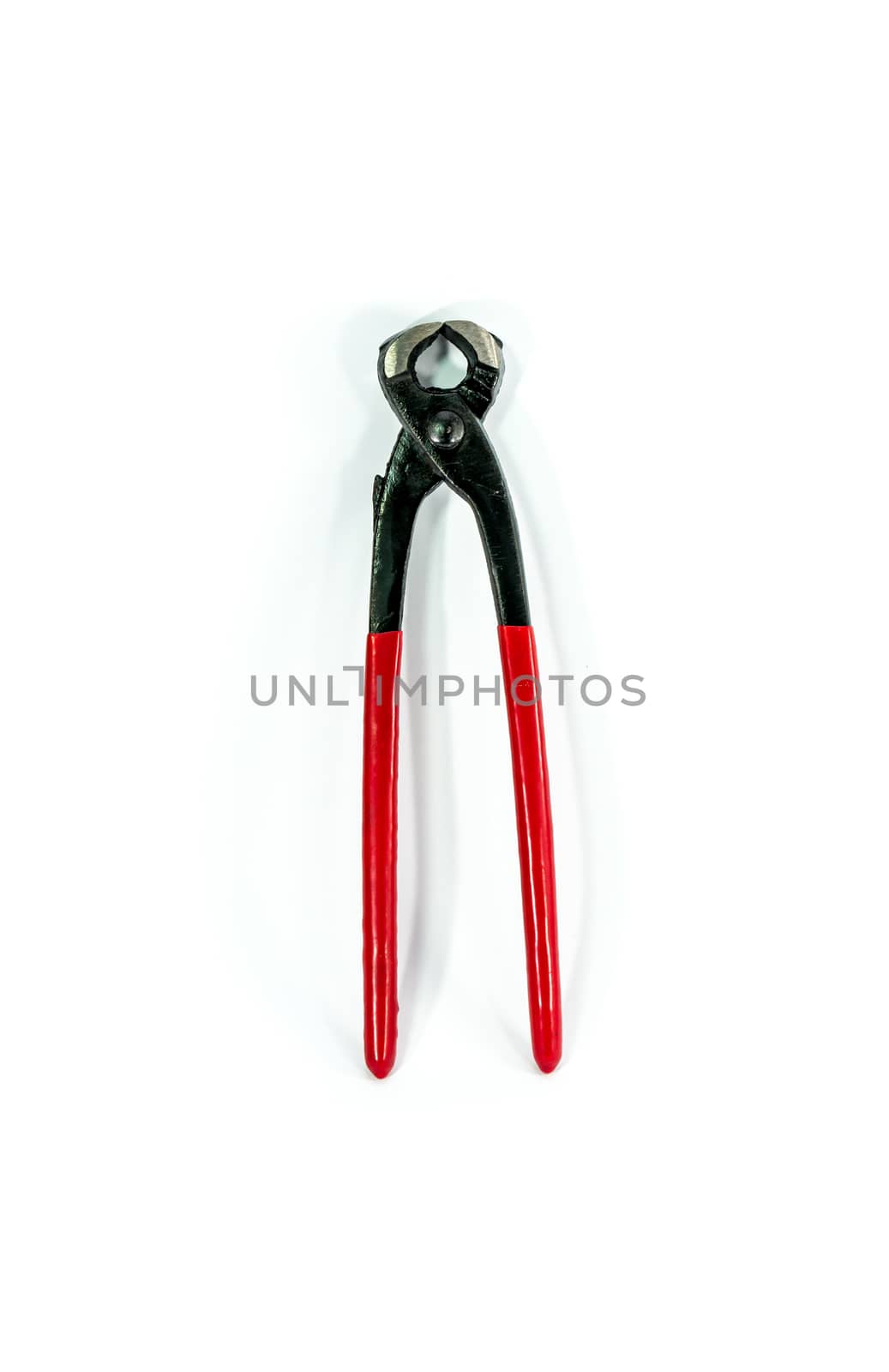 red metal pincers on white scene,shallow focus