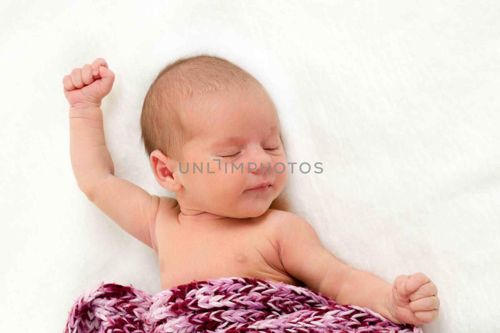 sleeping newborn baby in shawl on white blanket - the first week of the new life