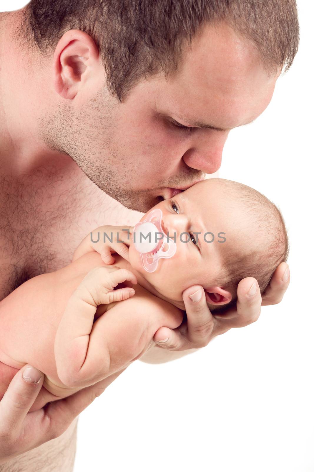 Loving father kissing his baby cute little girl, first month of the new life, isolated on white