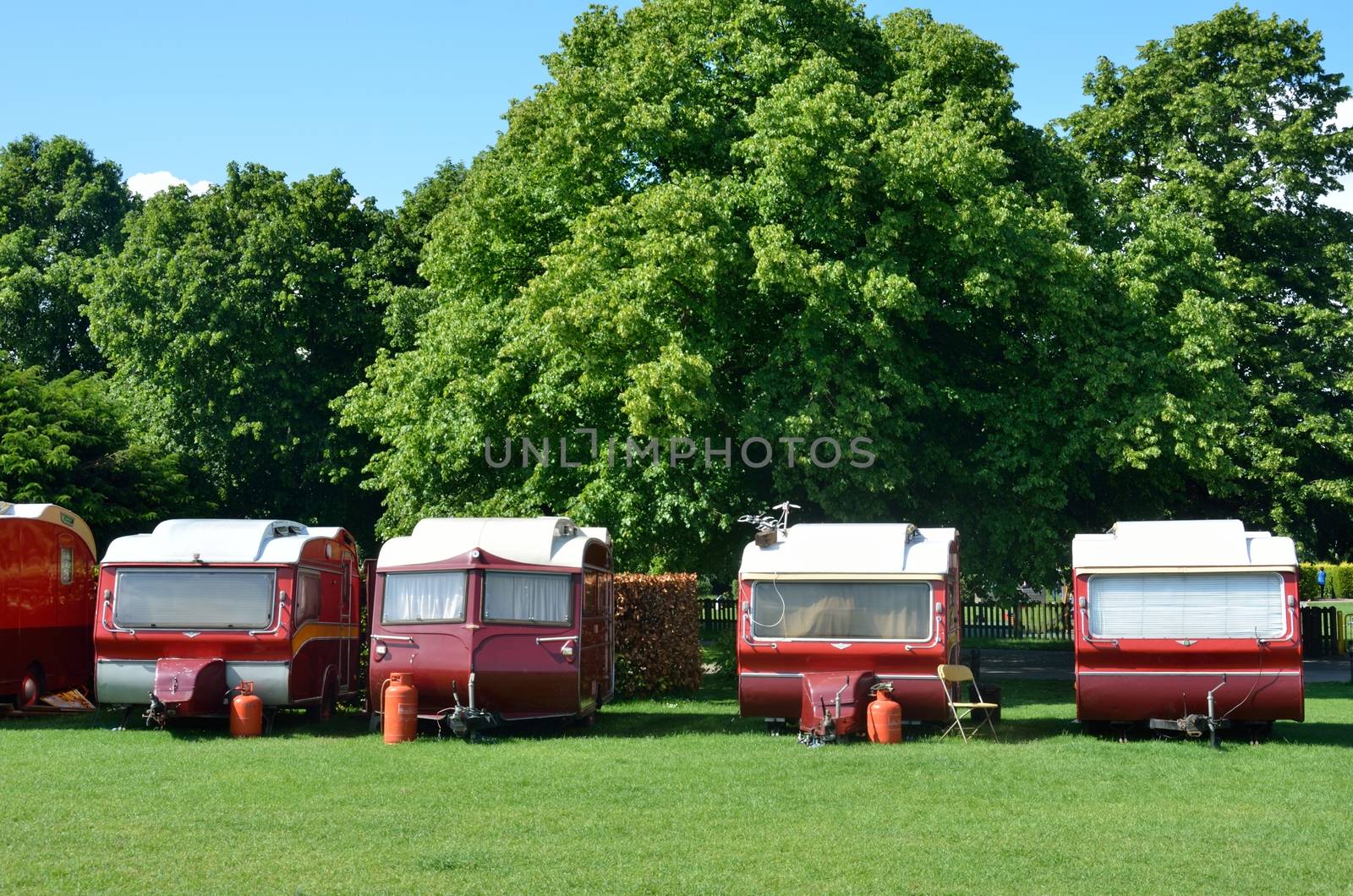 Line of red and cream caravans