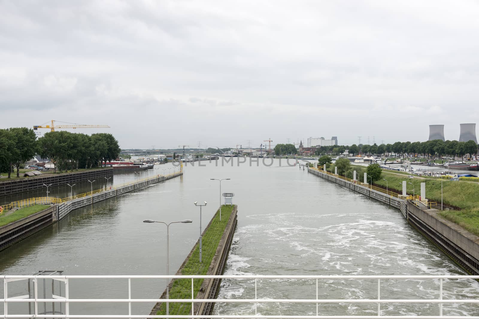 view from the maas river sluice at the city skyline maasbracht in holland