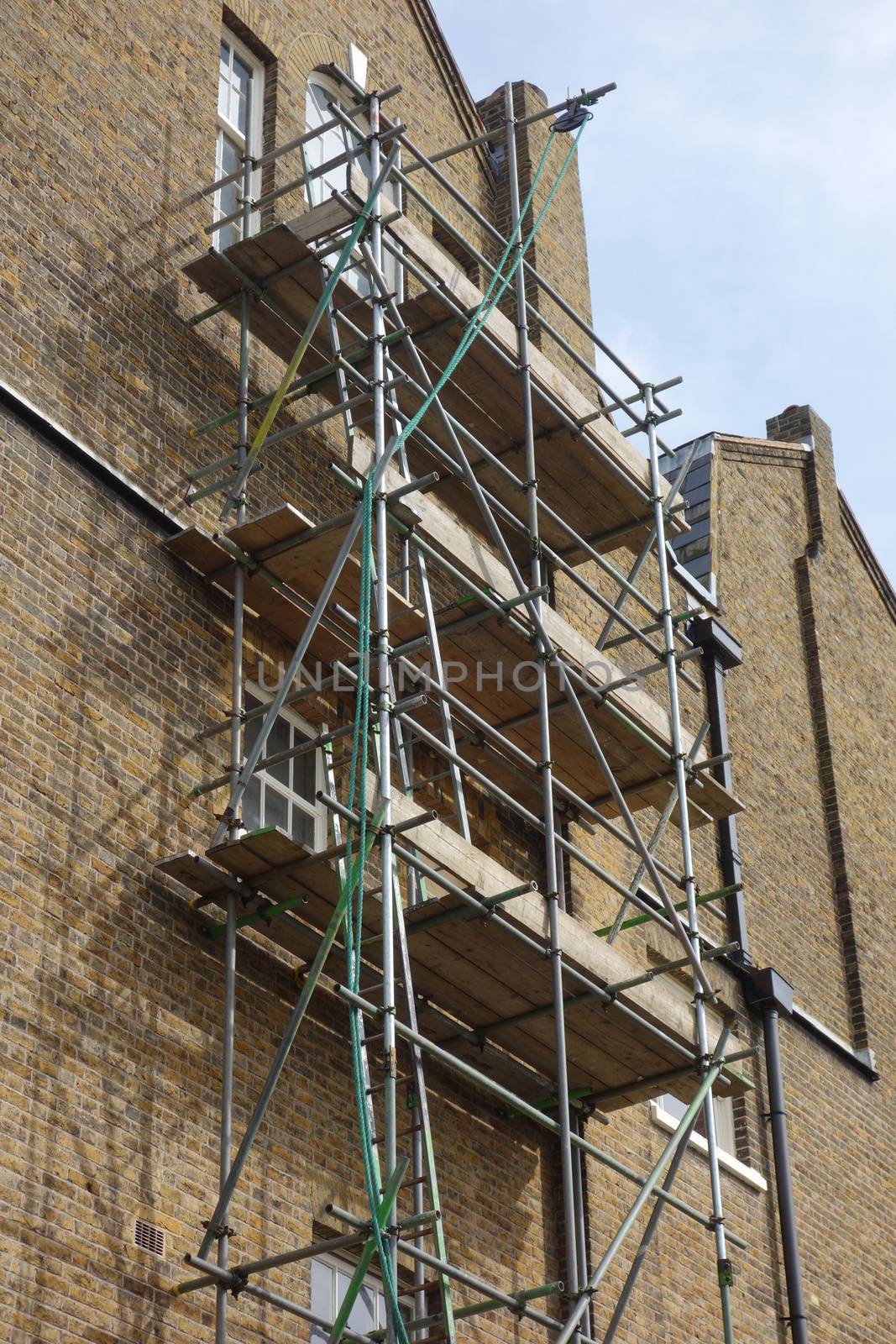 Scaffolding on side of tall brick building