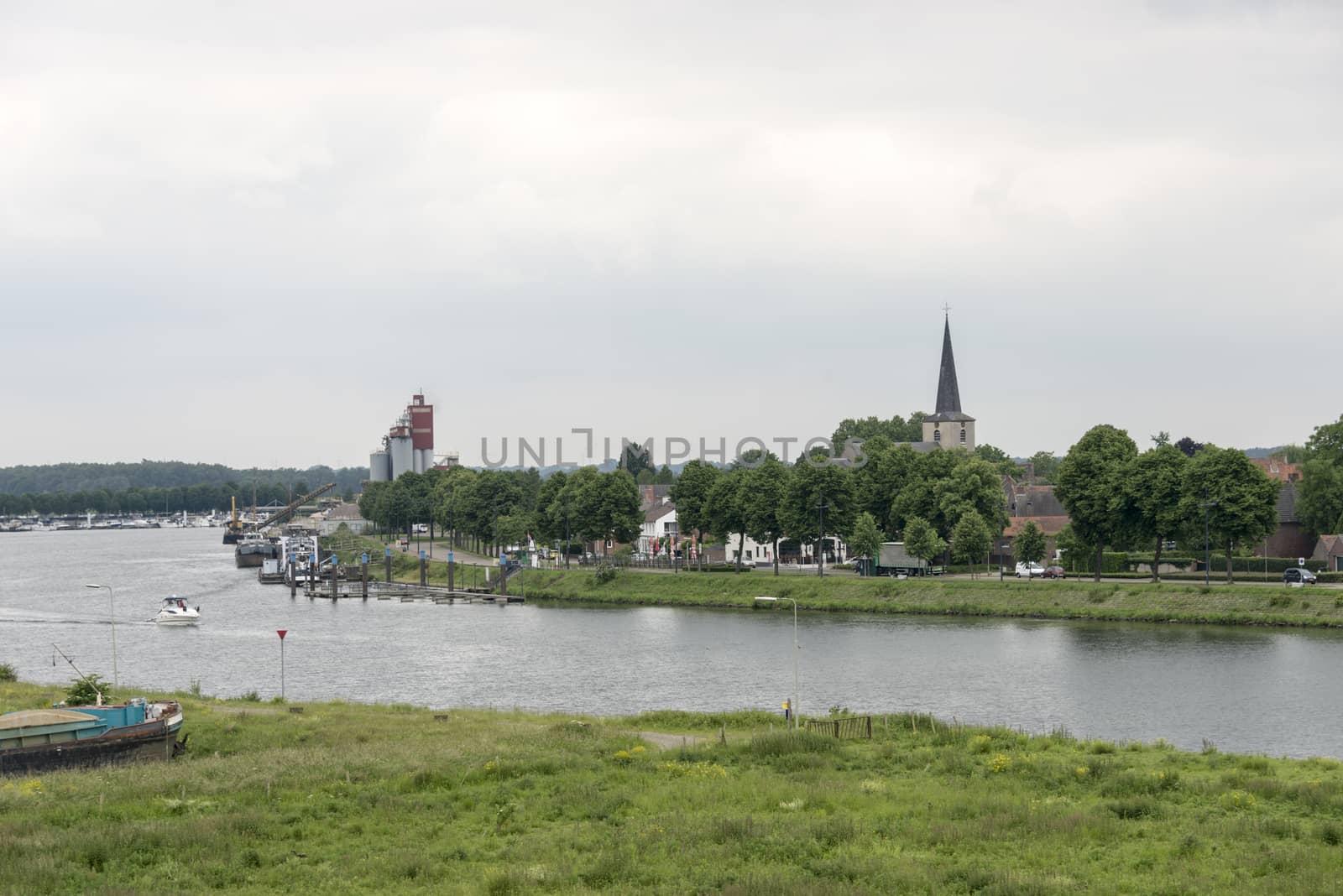 view on the dutch city skyline of wessem at the river maas