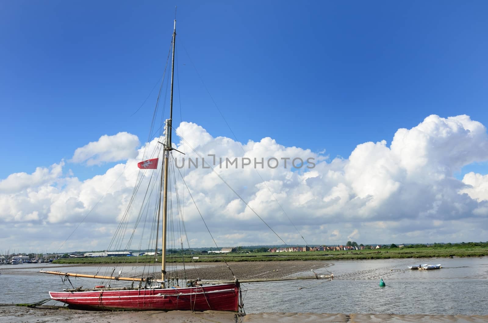 Red boat at low tide