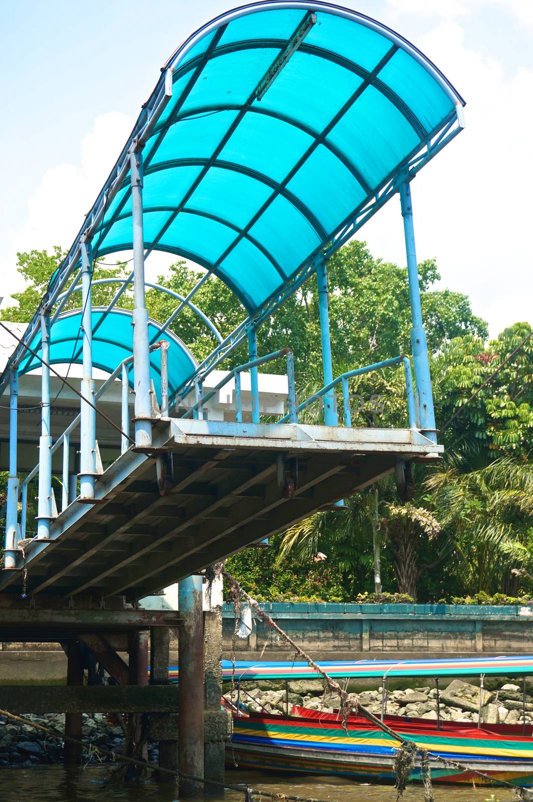 Old bridge of harbor with blue roof raise for repair.