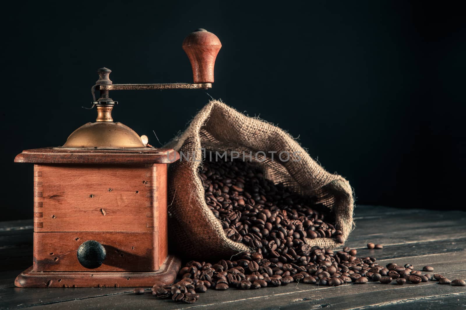 jute bag full of coffee beans and old grinder