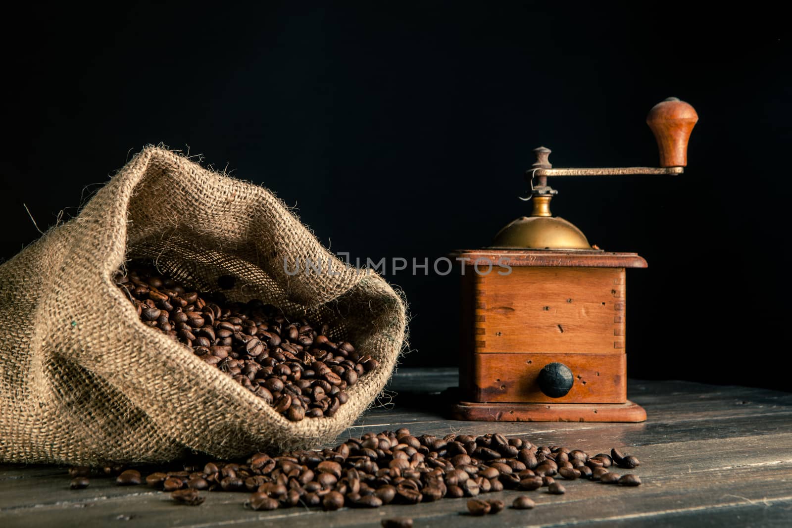 jute bag full of coffee beans and old grinder