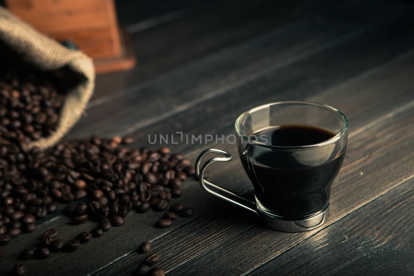 glass of coffee with coffee beans and other coffee tools