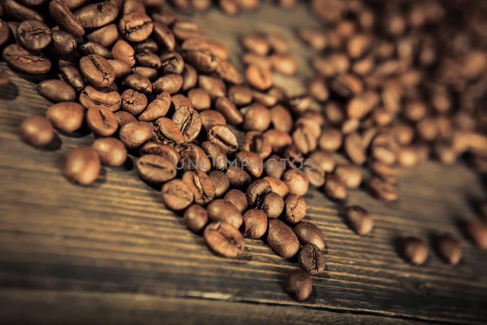 close up of coffee beans on a wooden table