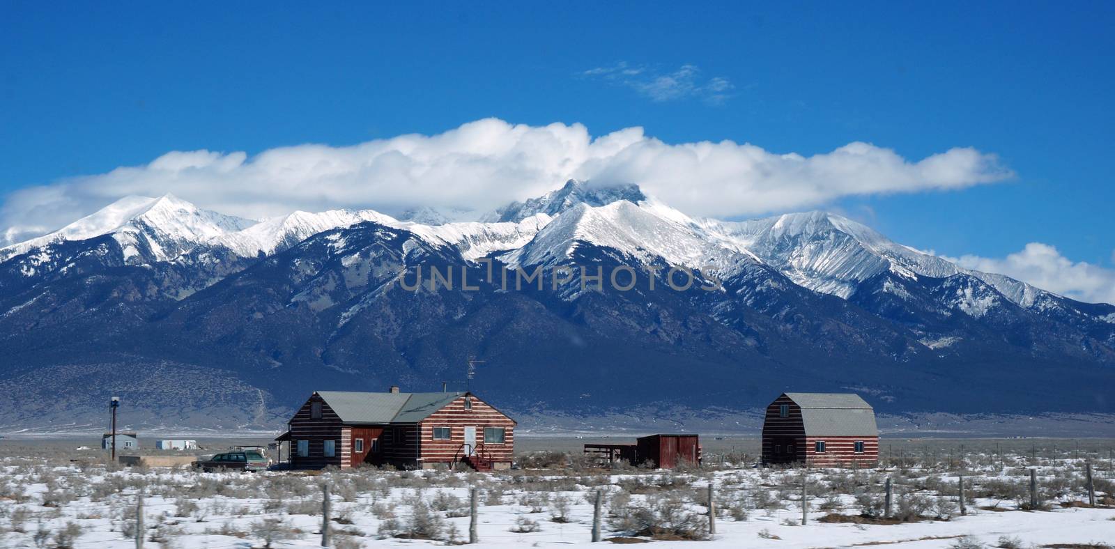 View of the Colorado winter with litter house and Rocky mountain as background.