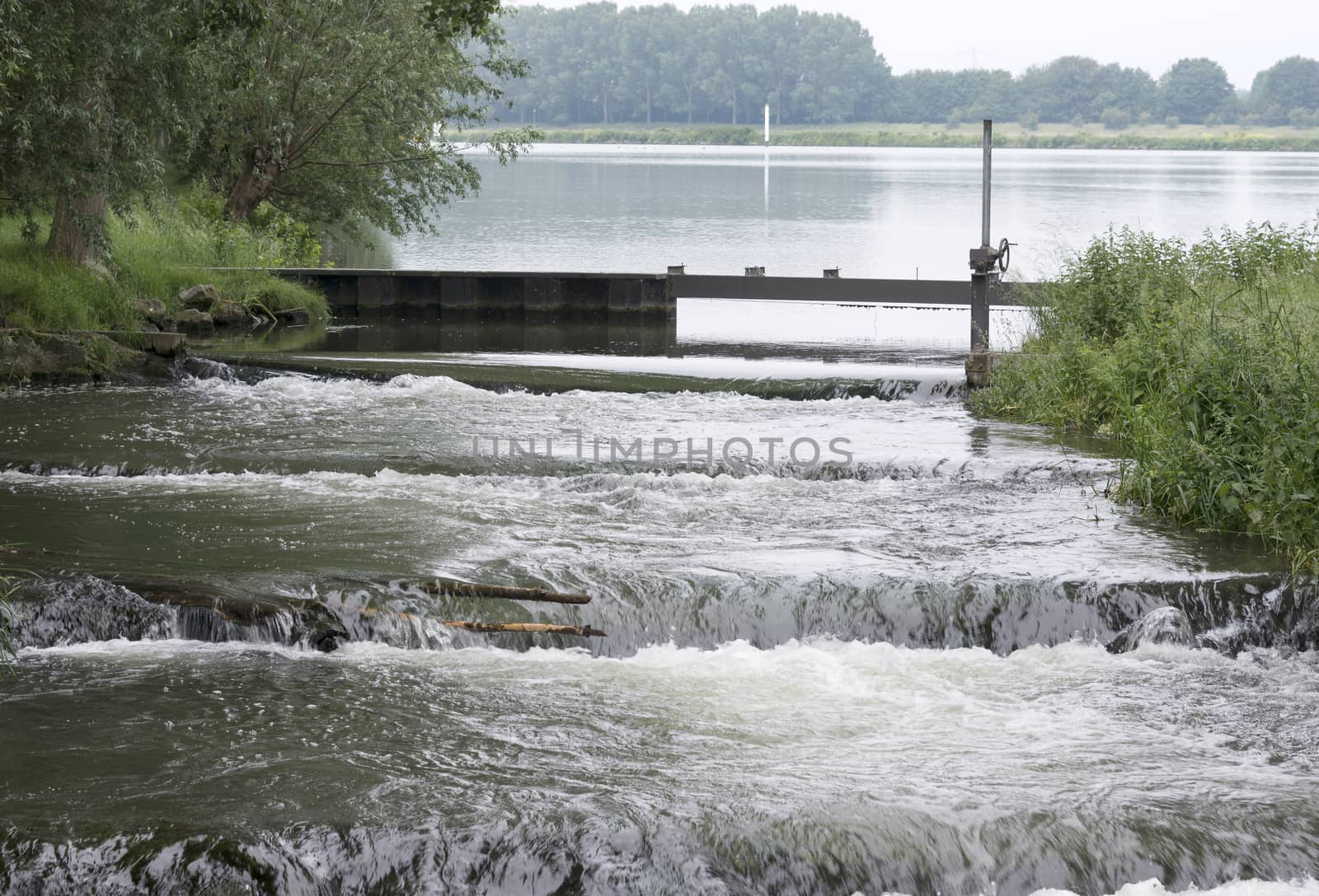 waterfall in holland from the river maas with green nature 
