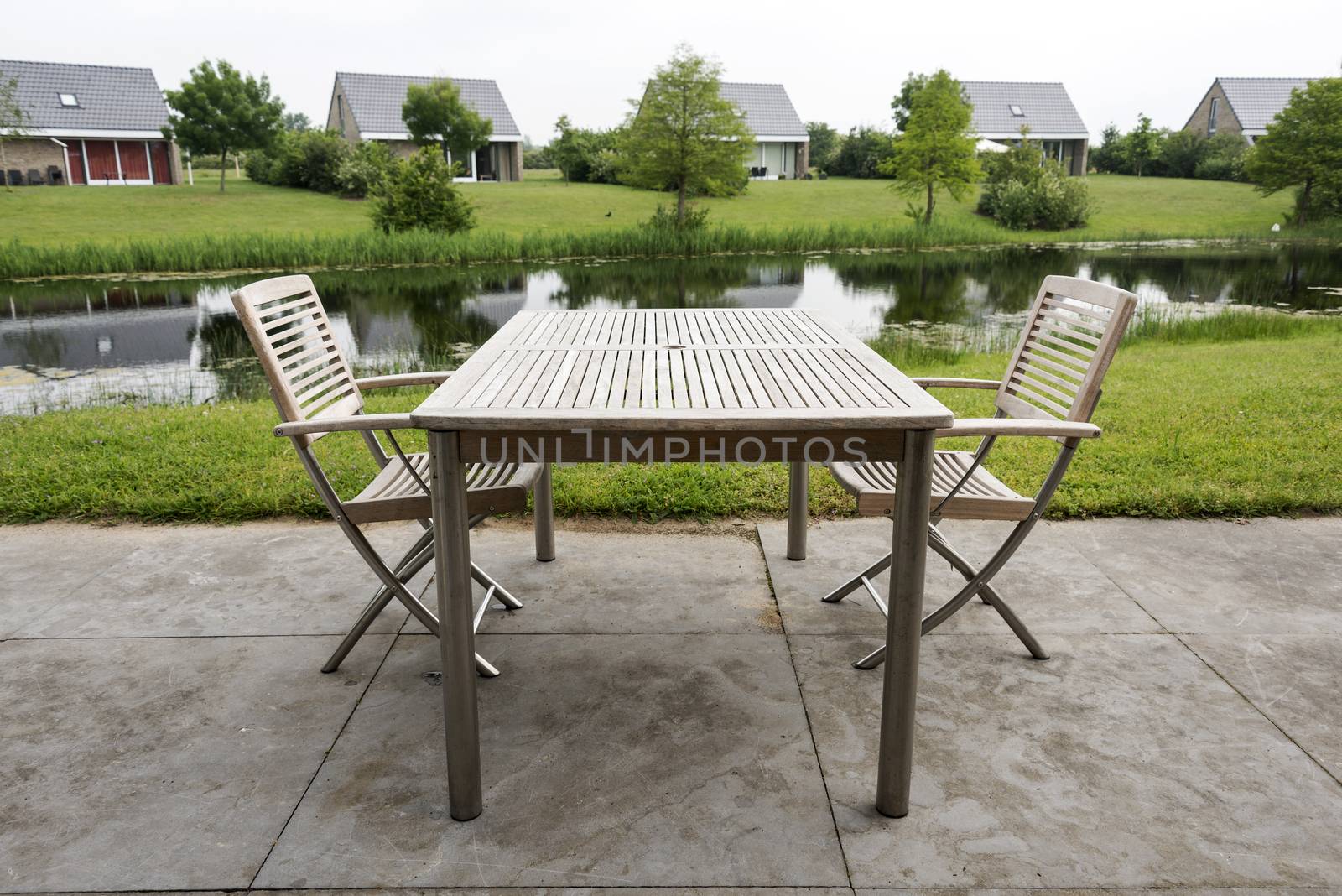 wooden chairs and table to relax on holiday near the water