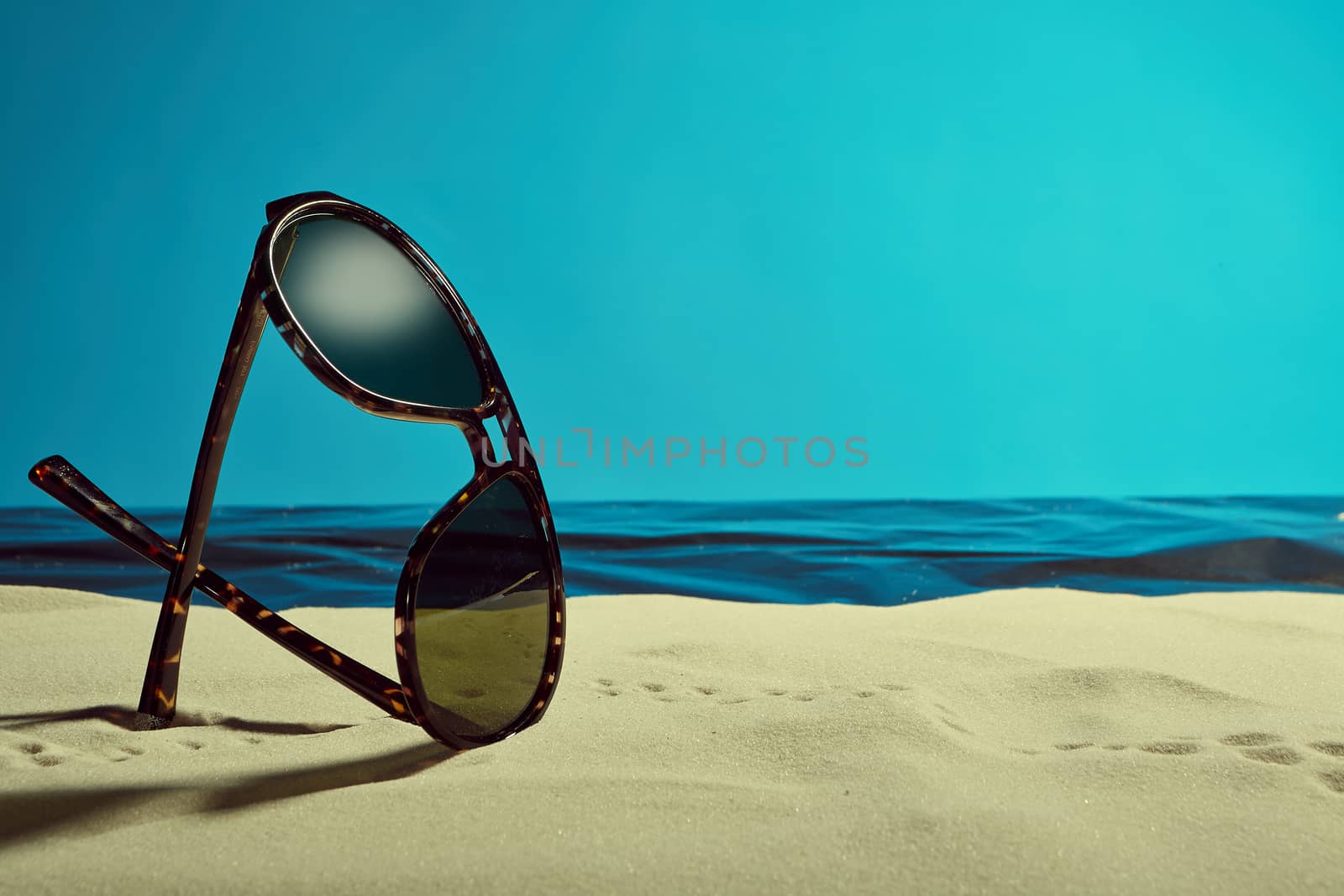 sunglasses on the beach by artnine