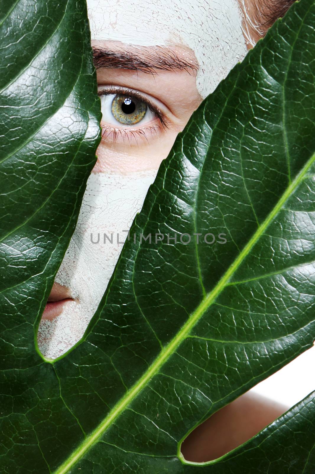 woman with a leaf in the mask with green clay