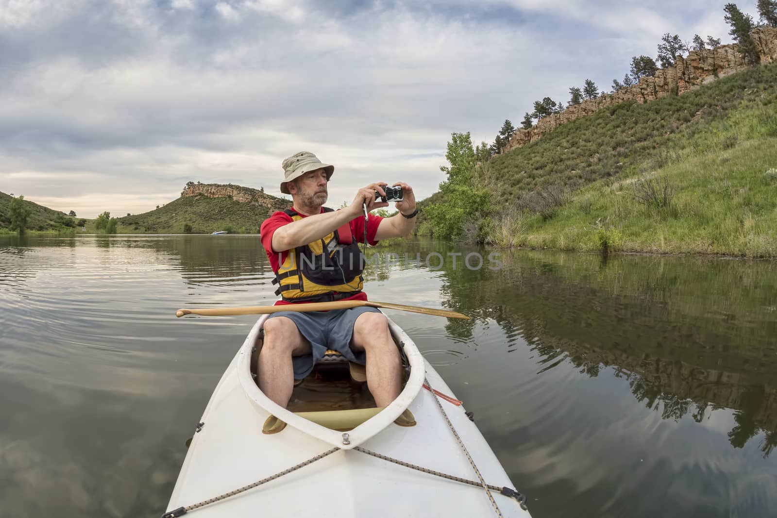 canoe paddler photographing by PixelsAway
