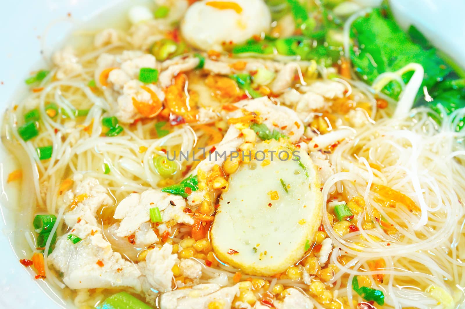 Thai noodle soup with rice noodle in a bowl.