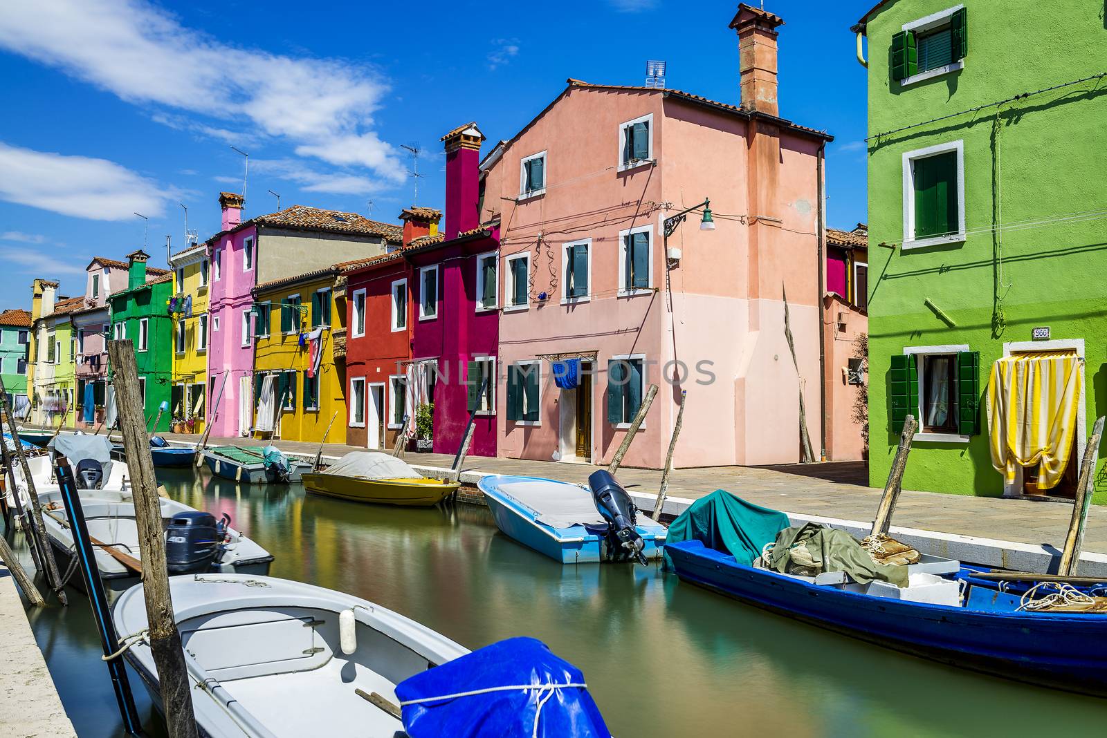 Colorful buildings in Burano island sunny street, Venise, Italy