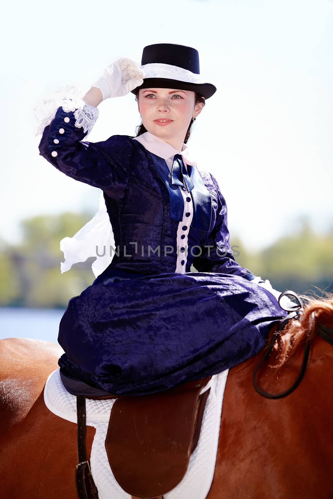 Lady on a  horse. The lady on riding walk. Portrait of the horsewoman. The woman astride a horse. The aristocrat on riding walk.