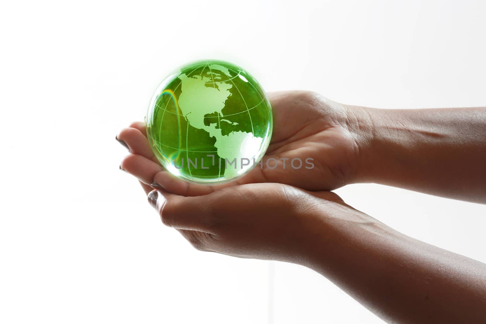 Green glass globe in the palm of your hands