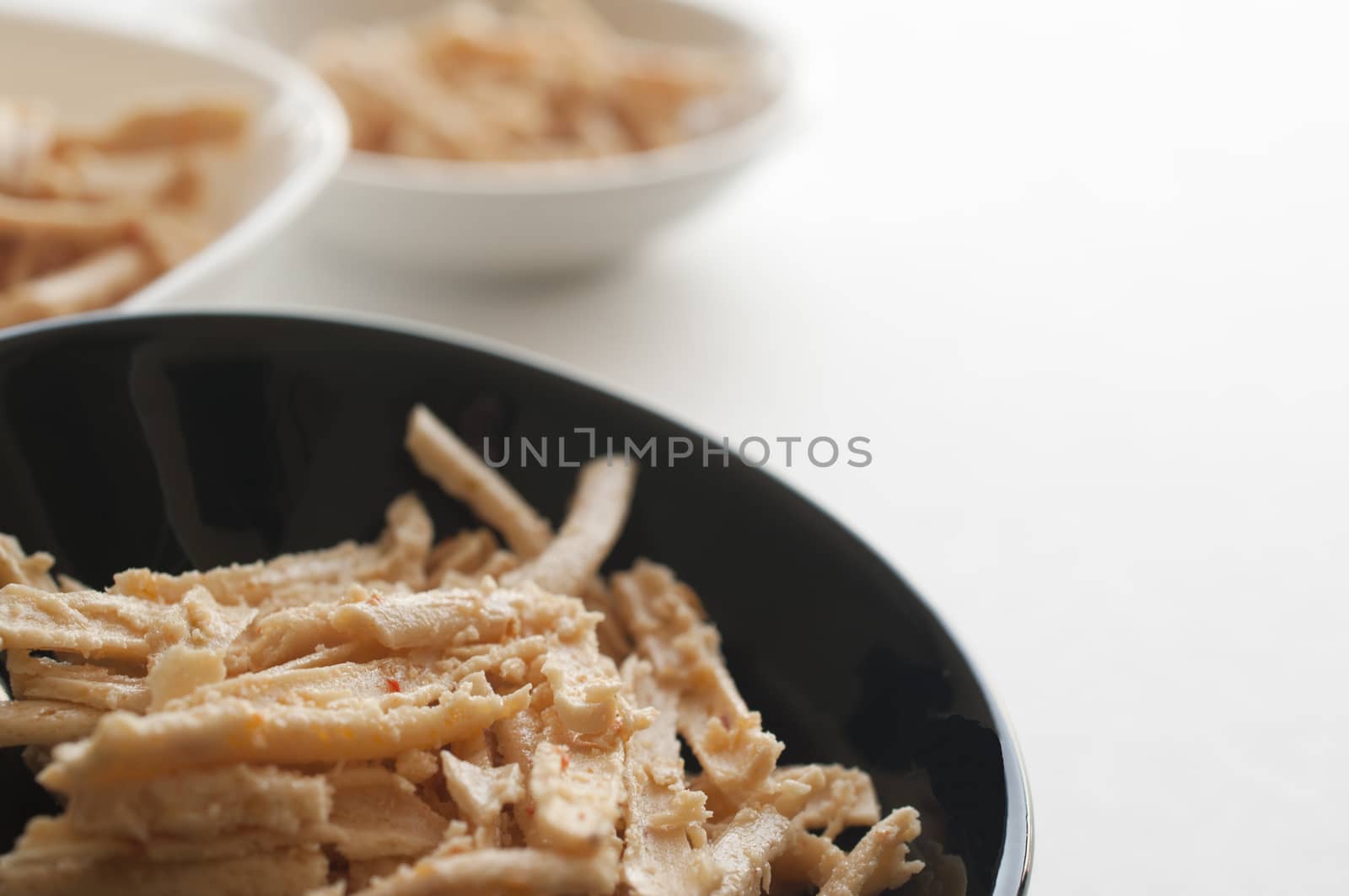 Cheese in bowls on white background