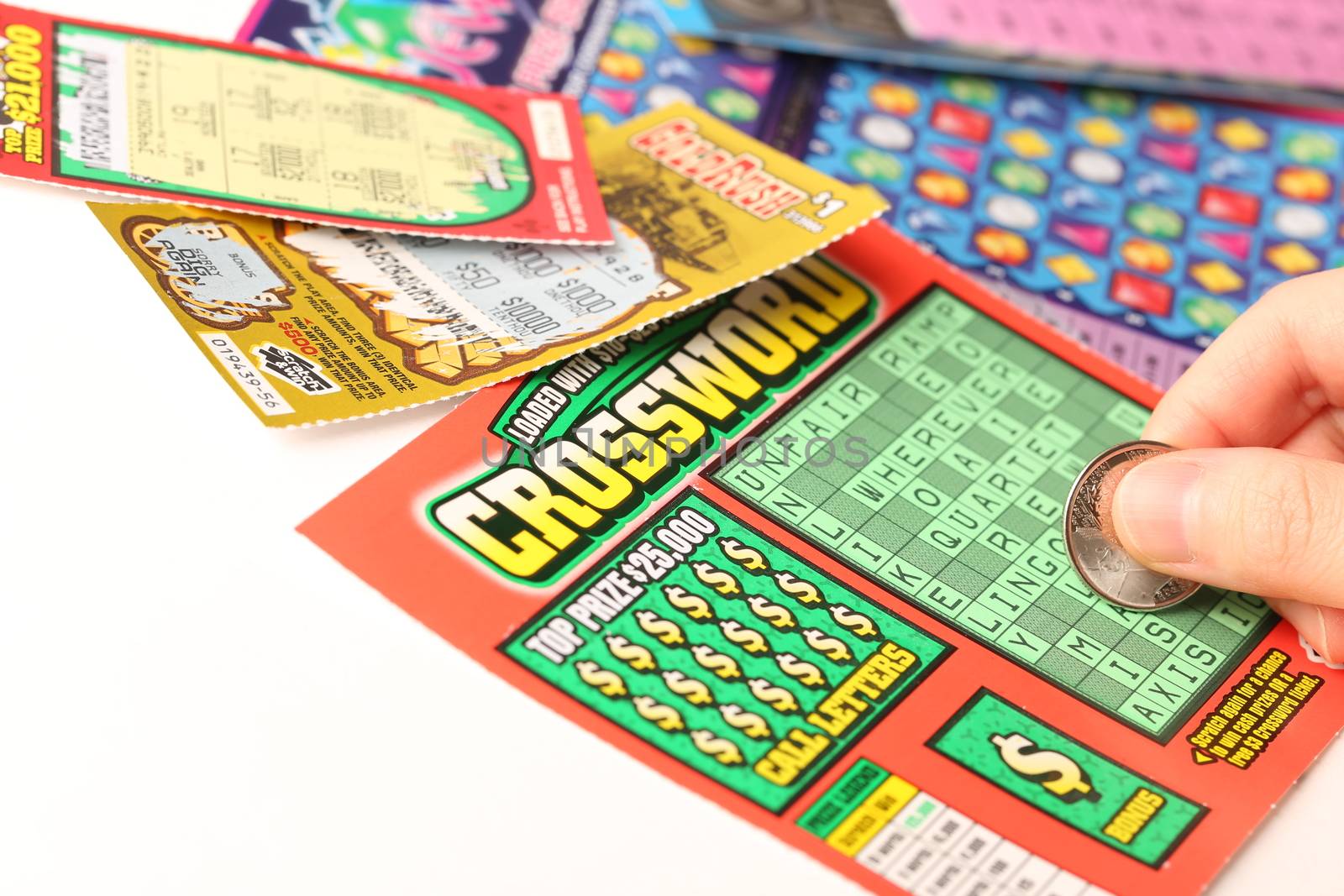 Coquitlam BC Canada - May 25, 2014 : Scratching lottery tickets. The British Columbia Lottery Corporation has provided government sanctioned lottery games in British Columbia since 1985. 