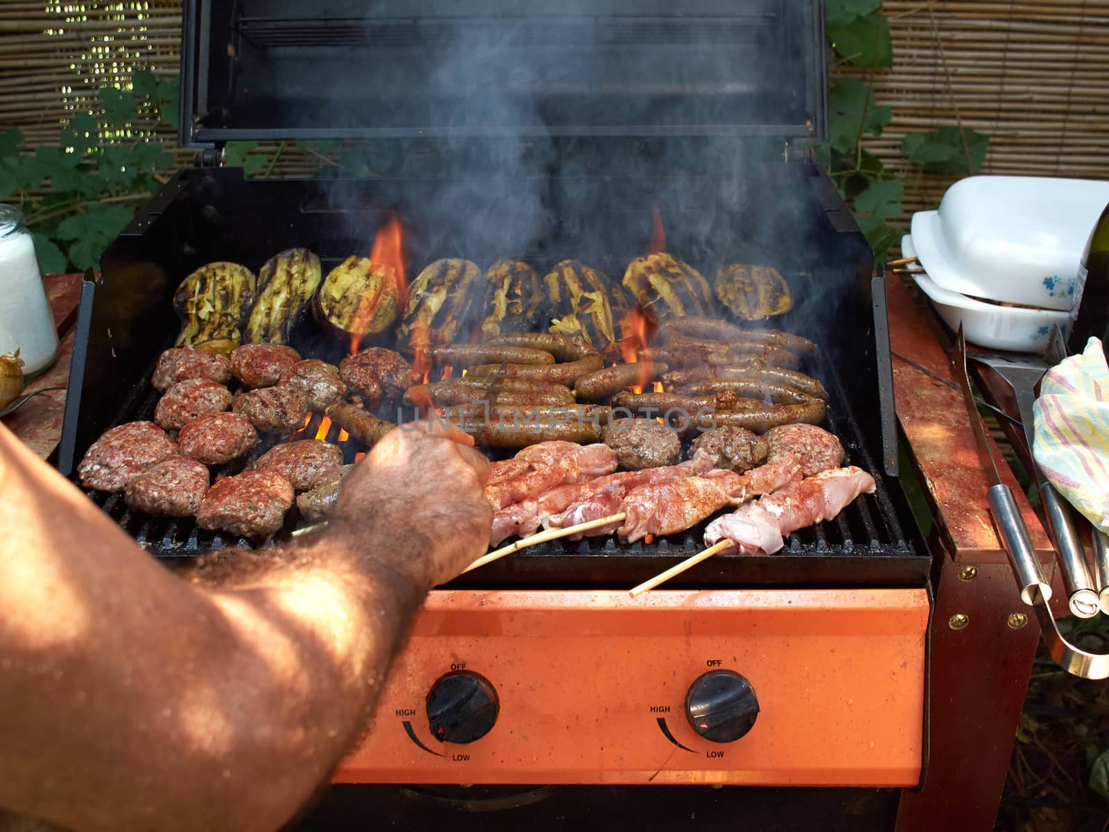 Delicious selection of meat bbq on grill in a big garden party meal     