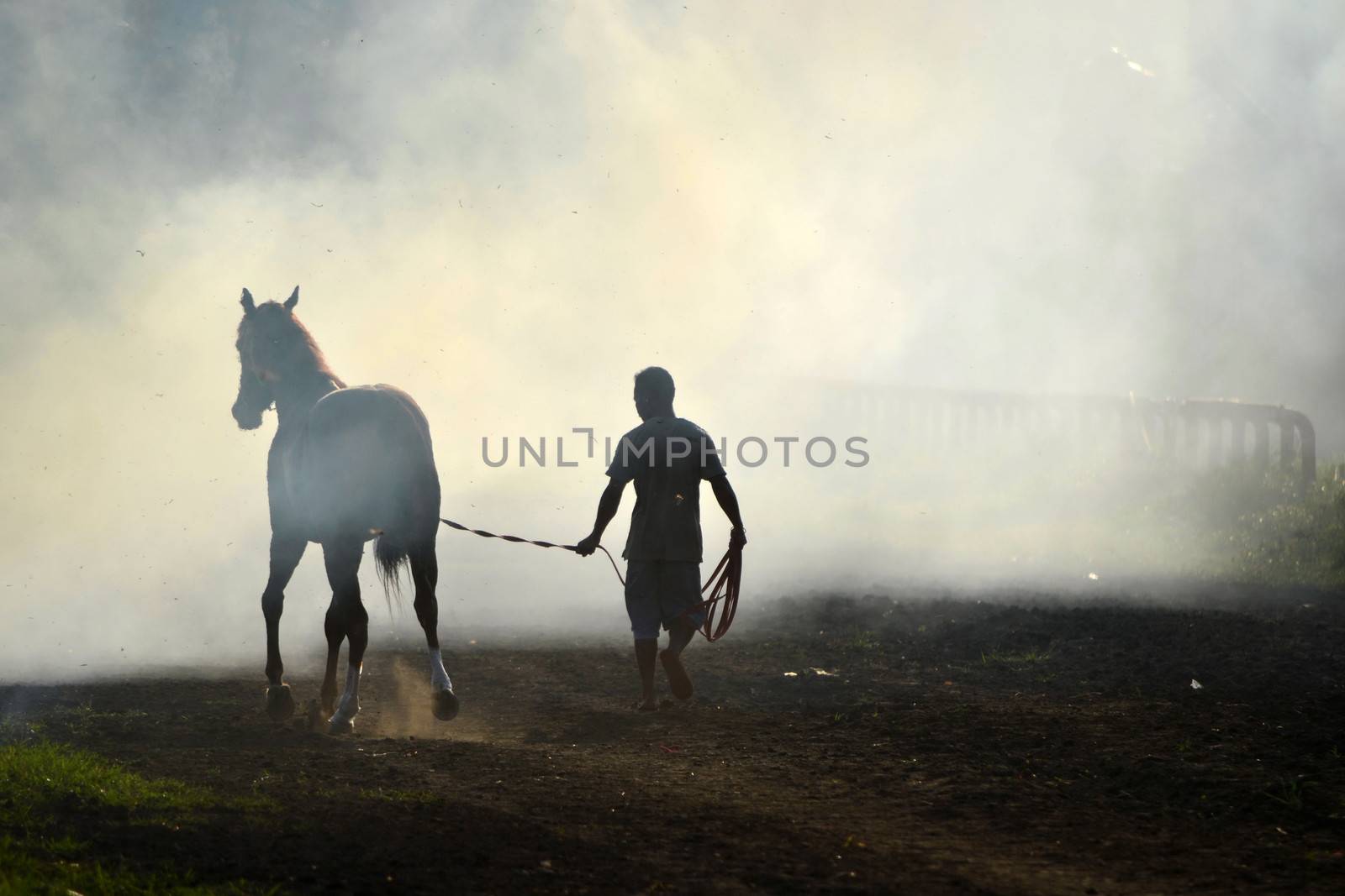 bandung, indonesia-may 31, 2014-man get walking together with his horse in arcamanik horse race arena