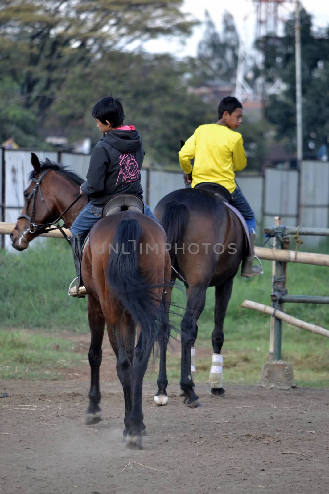 bandung, indonesia-may 31, 2014-young boy learn to riding a horse in arcamanik horse race arena