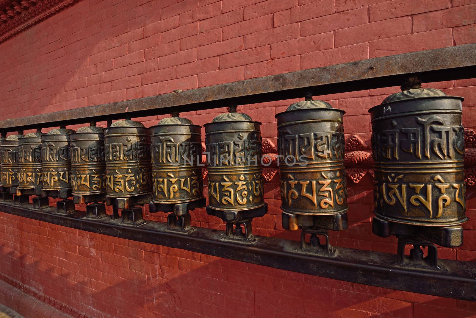 prayer wheels at swayambhunath temple in kathmandu, nepal by think4photop