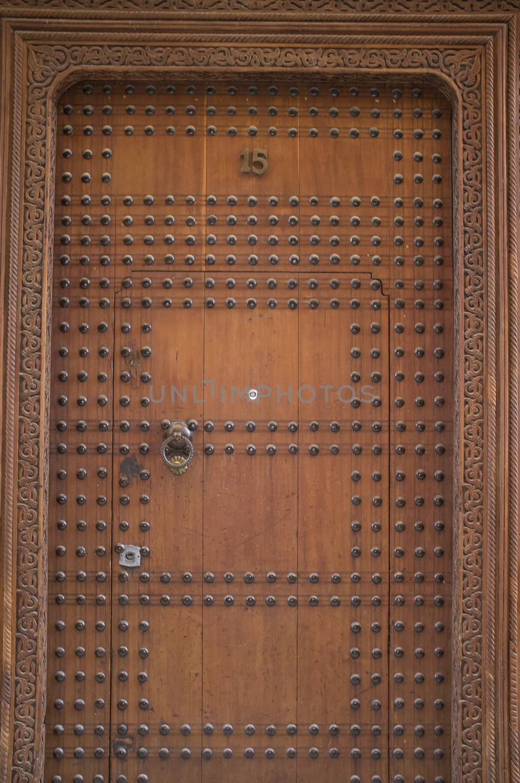 Studded wooden door to a historic Riad in the ancient city of Fes in Morocco, North Africa