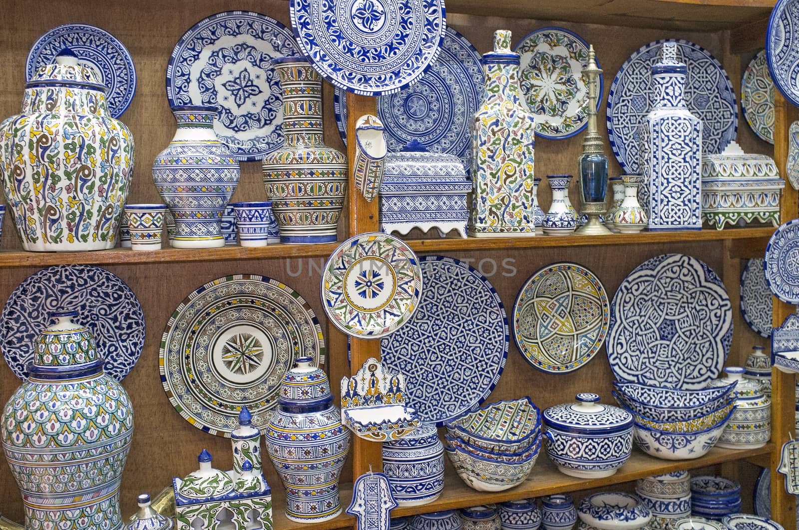 Traditional blue and white pottery for sale in a shop in the historic medina of Fes in Morocco
