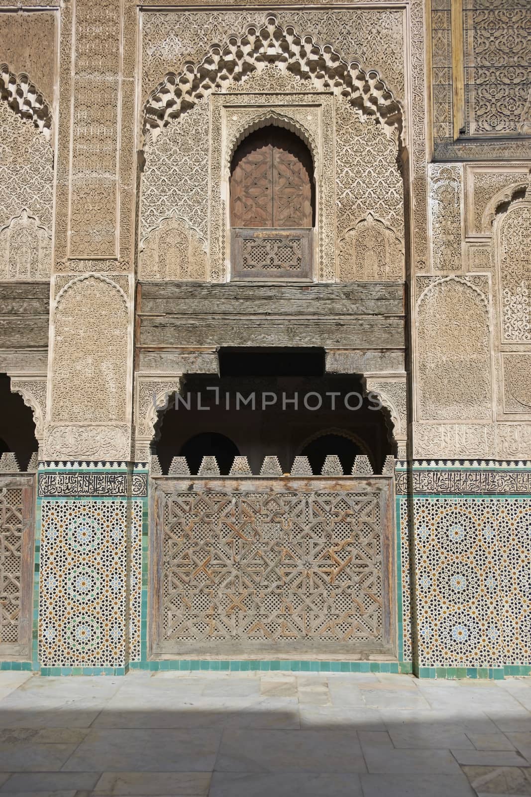 Ornate carving on the plastered walls and on the woodwork in the courtyard of the historic Madrasa Bou Inania in the ancient medina of Fes in Morocco