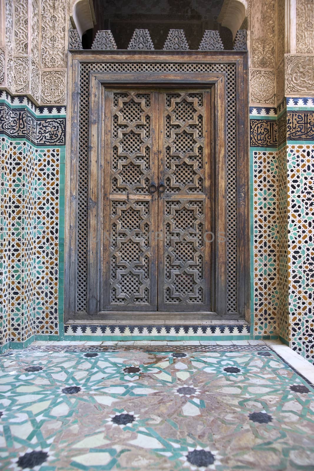 Ornate carving on the plastered walls and on the woodwork in the courtyard of the historic Madrasa Bou Inania in the ancient medina of Fes in Morocco