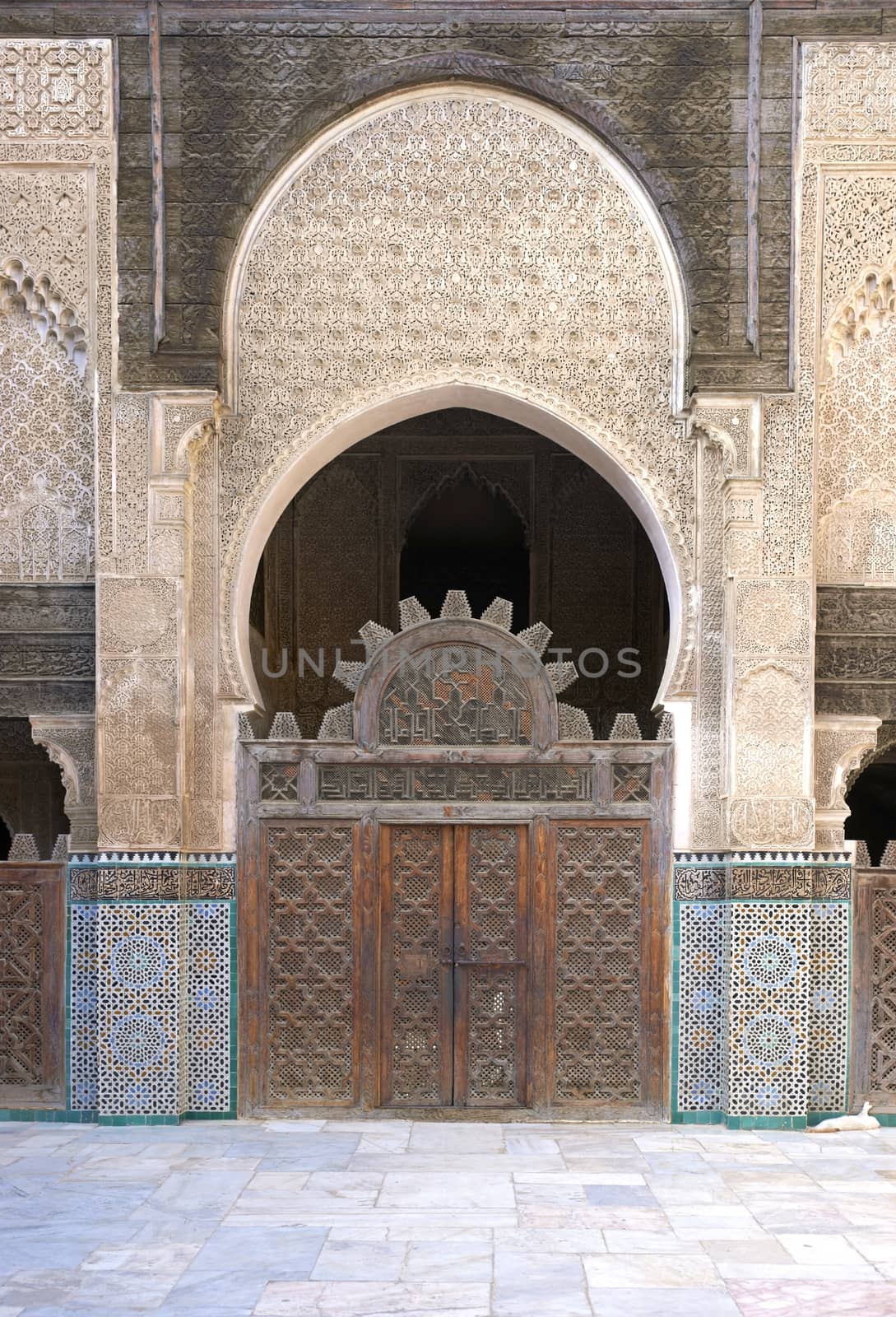 Ornate carving on the plastered walls and on the woodwork in the courtyard of the historic Madrasa Bou Inania in the ancient medina of Fes in Morocco