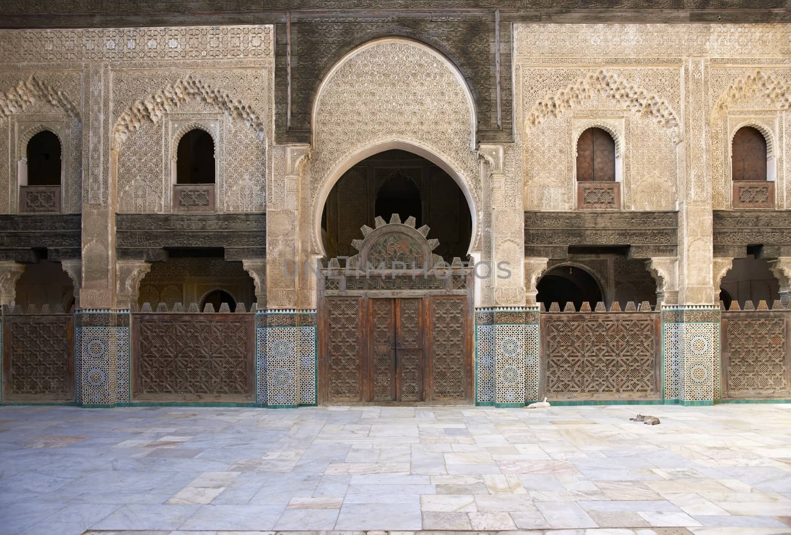 Ornate carving on the plastered walls and on the woodwork in the courtyard of the historic Madrasa Bou Inania in the ancient medina of Fes in Morocco